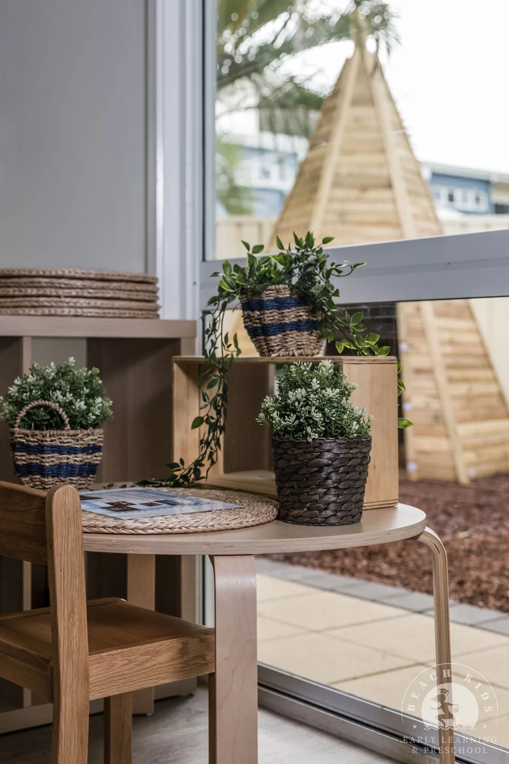 A timber table beside the window looking out to the Cabarita yard
