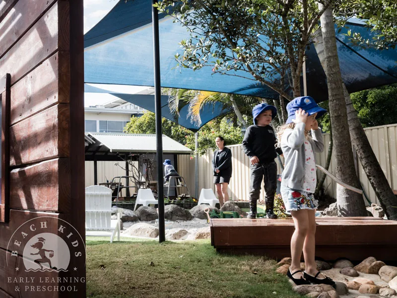 Children playing under the shade sails in the Cabarita outdoor yard