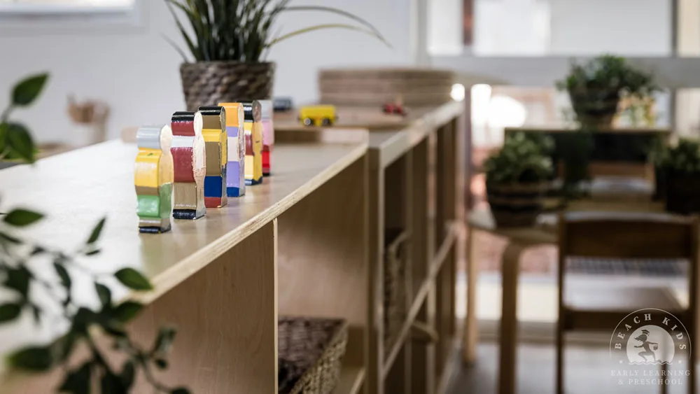 Colourful stacking blocks lined up along a timber shelf at Beach Kids Cabarita