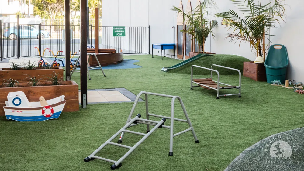 The boat and climbing frame on the grass yard at Beach Kids Cabarita
