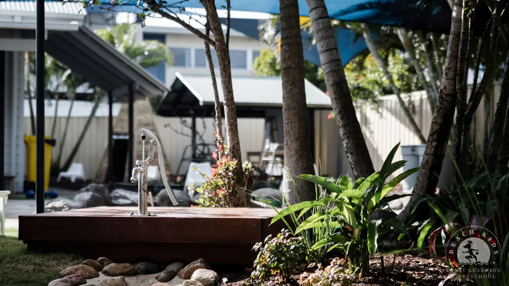 Tropical planting and rocks around the water play area at Beach Kids Cabarita